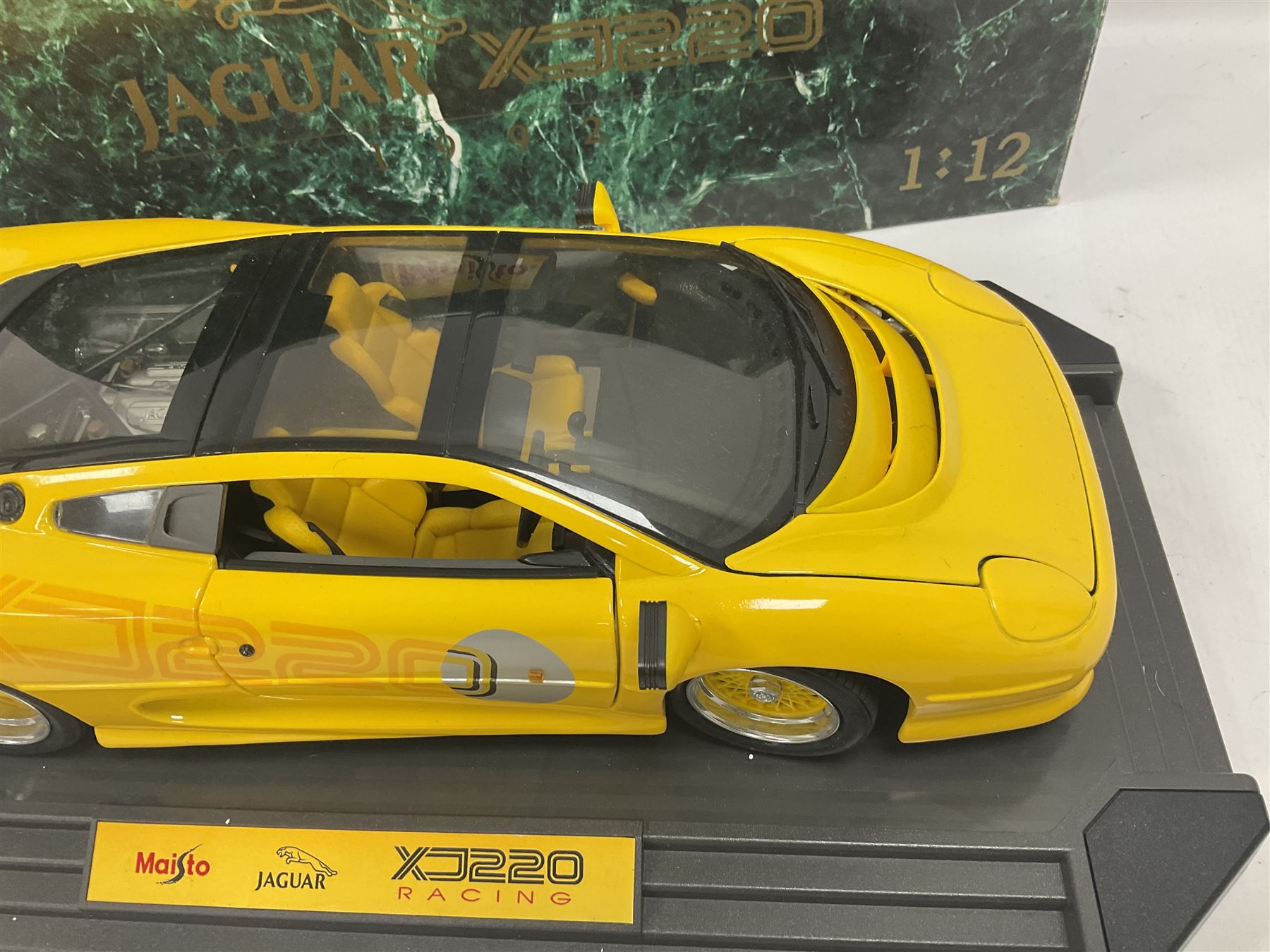 Two Maisto 1:12 scale Jaguar XJ220 ‘Racing’ cars in yellow, both on plinths in original boxes 