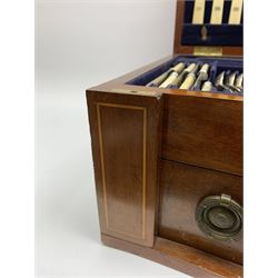 Late 19th/early 20th century composite canteen of silver flatware, contained within an early 20th century mahogany serpentine fronted case with twin drop carry handles, and hinged cover with boxwood stringing and central inlaid shell motif, above a single drawer with twin ring handles and Wellington style locking system, the cover and drawer opening to reveal plaque for Spink & Sons Ltd London, and fitted interior containing ivory handled knives, ivory handled carving set, and silver Hanoverian and Old English pattern cutlery, each with engraved monogram to terminal, hallmarked London, makers Spink & Son (John Marshall Spink), Goldsmiths & Silversmiths Co, and Chawner & Co (George William Adams), various dates ranging 1880-1923, gross weighable silver 92.59 ozt (2880 grams)