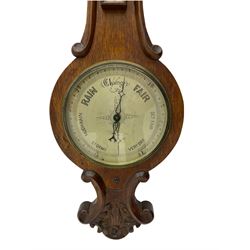 Late-19th century oak cased wheel barometer, 8” silvered dial with weather predictions, recording air pressure from 28 to 31 inches, steel indicating hand and brass recording hand, within a convex glass and cast brass bezel, with a removable mercury thermometer box, mercury capillary tube and counterweights.

