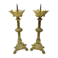 Pair of gilt metal pricket candlesticks, with applied decoration on knopt stems and triform bases, H47cm