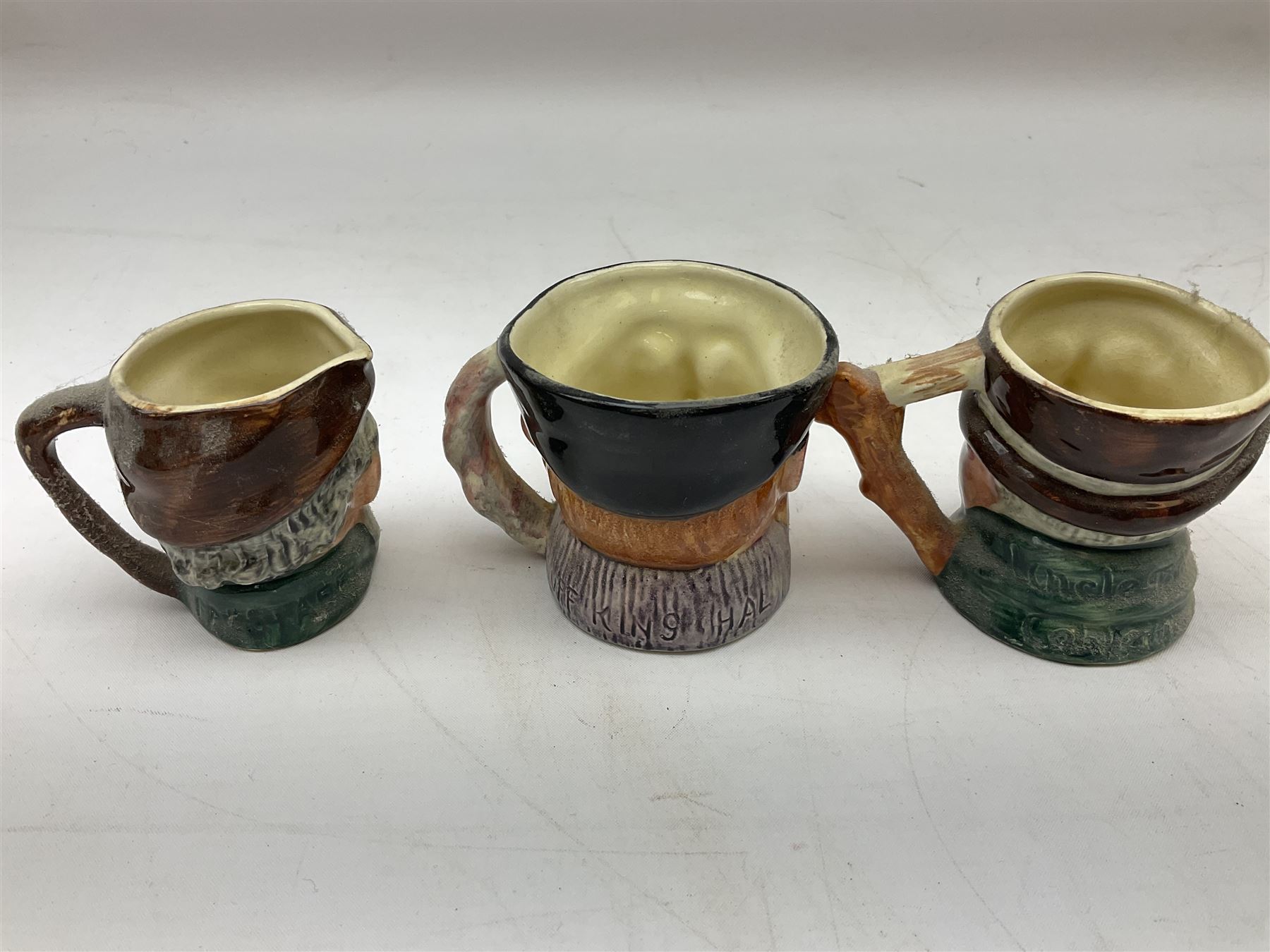 John Beswick figure of a seated piglet, Beswick Beatrix Potter Mrs Rabbit and Peter figure, and quantity of Sandland Character Ware jugs