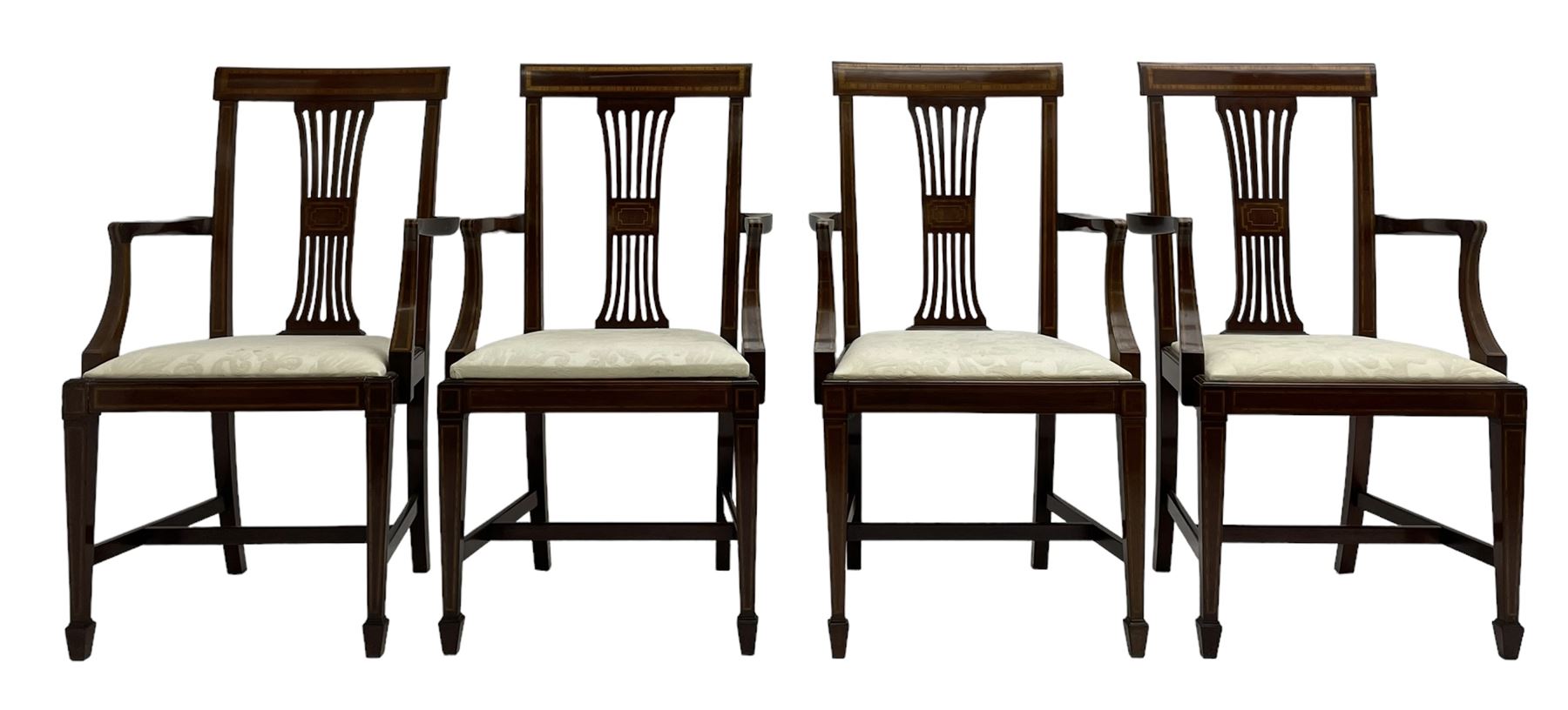 Set twelve (4+8) Edwardian inlaid mahogany dining chairs, cresting rail with satinwood banding, pierced splat backs with central inlay, drop-in seats upholstered in foliate patterned ivory fabric, raised on square tapering supports terminating in spade feet