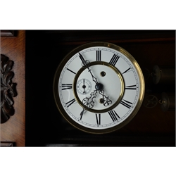  Late 19th century figured walnut Vienna wall clock, stepped arch pediment with turned finials, white enamel dial with subsidiary seconds hand, H122cm  