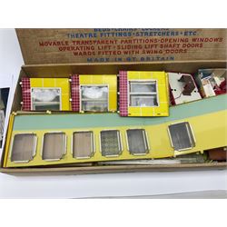 Late 1950s/early 1960s Mettoy tin-plate Emergency Ward 10 hospital set from the TV series, including over twenty figures, over sixty pieces of hospital equipment, beds, chairs, lockers, theatre fittings, stretchers etc; building is complete with movable transparent partitions, operating lift with sliding lift shaft doors and opening windows; wards with fitted swing doors; tin-plate walls with lithographed detail in yellow with red and white tiled effect, cobbled base with ambulance casualties area and lift access; boxed with instructions