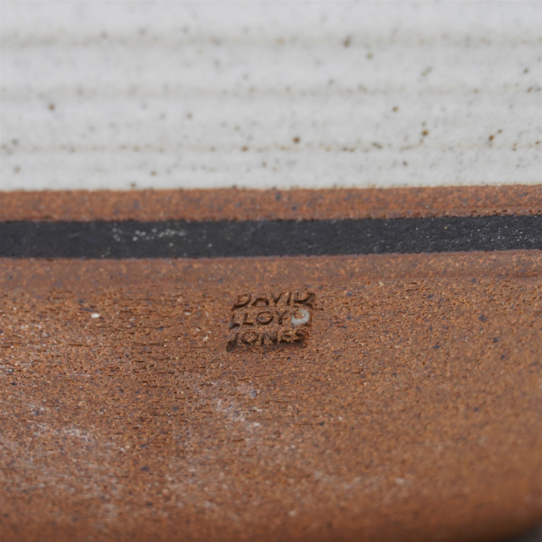 David Lloyd Jones (1928-1994); large studio pottery stoneware bowl, in speckled grey glaze with irregular iron rim, impressed mark to base, D32cm 