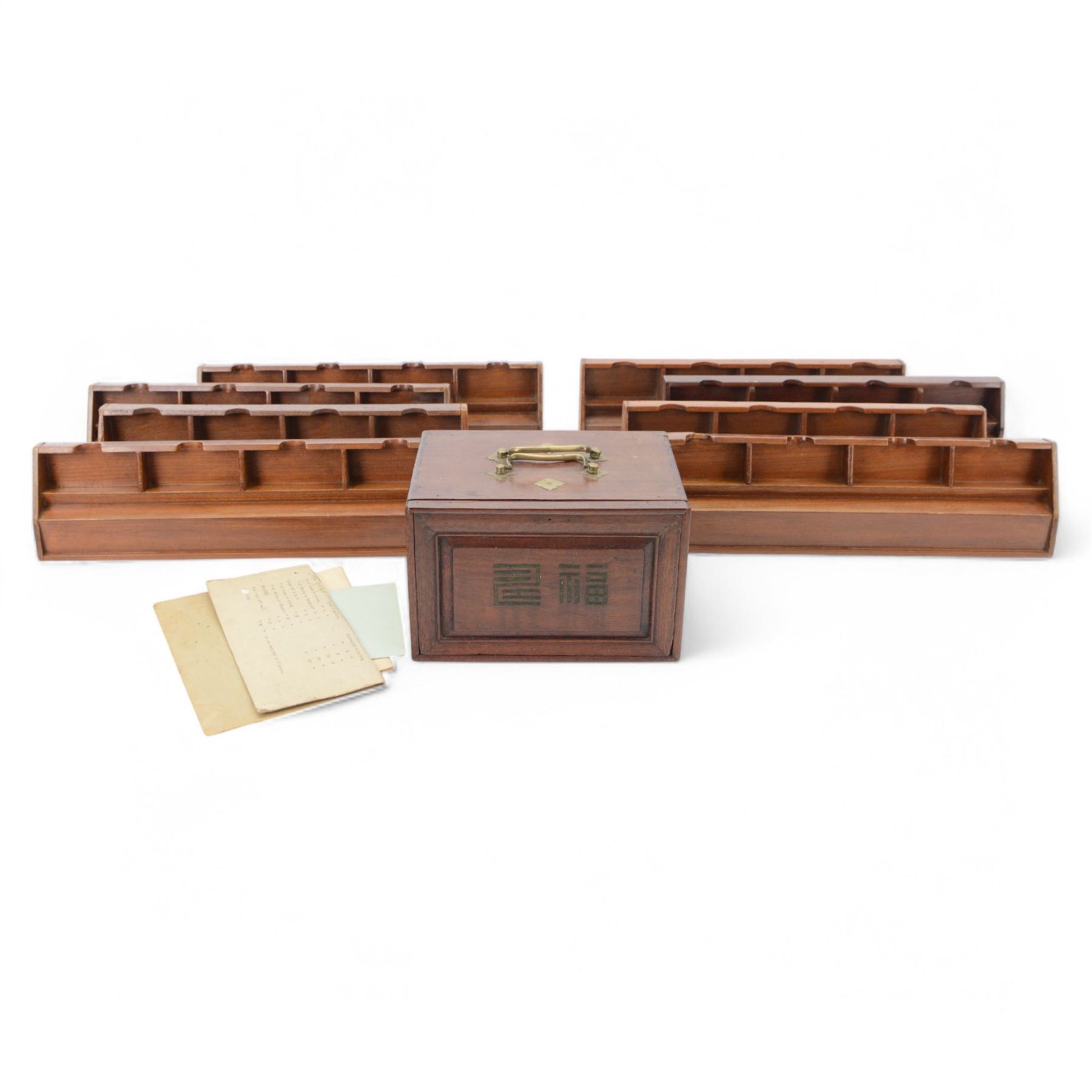 20th century Chinese Mahjong set, with five drawers containing bone counters and tiles, contained within a wooden box with brass detailing, together with a set of eight wooden Mahjong tile trays
