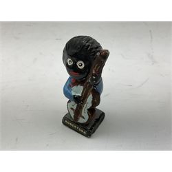 Robinson Jam plaster Golly band, including drummer and singer, H7.5cm

Originally handmade by mothers in Africa for their children from old fabric and cloth, the golly doll was adopted as the mascot and trademark for the Robertson's confectionery brand around 1910 after the company's founder John Robertson visited the US and noticed children playing with them. Robertson's Gollies have been collected by people across the UK and around the world for generations but garnered a contentious image in the 1980s because of links to racism. The trademark was removed from Robertson's branding in 2001.