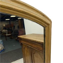 19th century giltwood overmantel mirror, arched moulded frame with plain mirror plate, shaped lower brackets on ceramic compressed bun feet