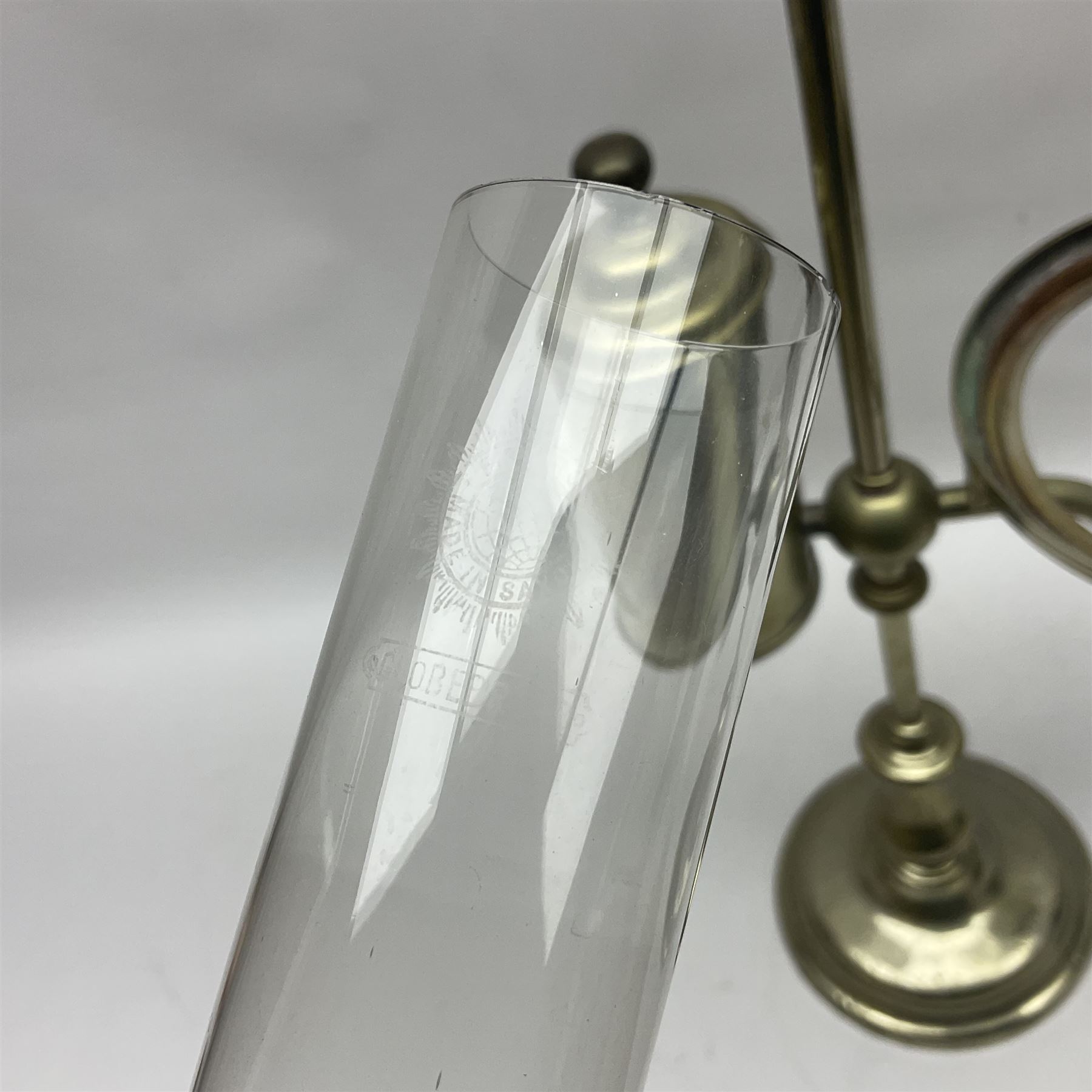 William H Honey polished brass adjustable student's oil lamp, with green glass shade, H60cm