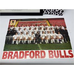 Hull F.C. memorabilia; Clive Sullivan 1986 memorial game programme, Open Evening 1994 programme with multiple player signatures, 'Old Faithful' 45rpm record, Wembley rosettes, 2000 team poster with facsimile signatures, framed print 'Farewell to the Boulevard 1895-2002', fully signed team photograph, various booklets, CD, DVD etc; and a folder containing the Merlin Rugby League card collection