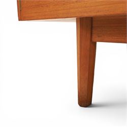 Mid-20th century teak sideboard, rectangular top above four frieze drawers with recessed handles, flanked by two cupboard doors with fall front central media cupboard