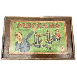 Meccano - wooden box with Set No.5 label to sliding lid, containing two lift-out trays and bottom layer of predominantly red and green sections, wheels, pulleys, rods, tyres etc, carrying handles to either end, L36cm D22.5cm H13.5cm
