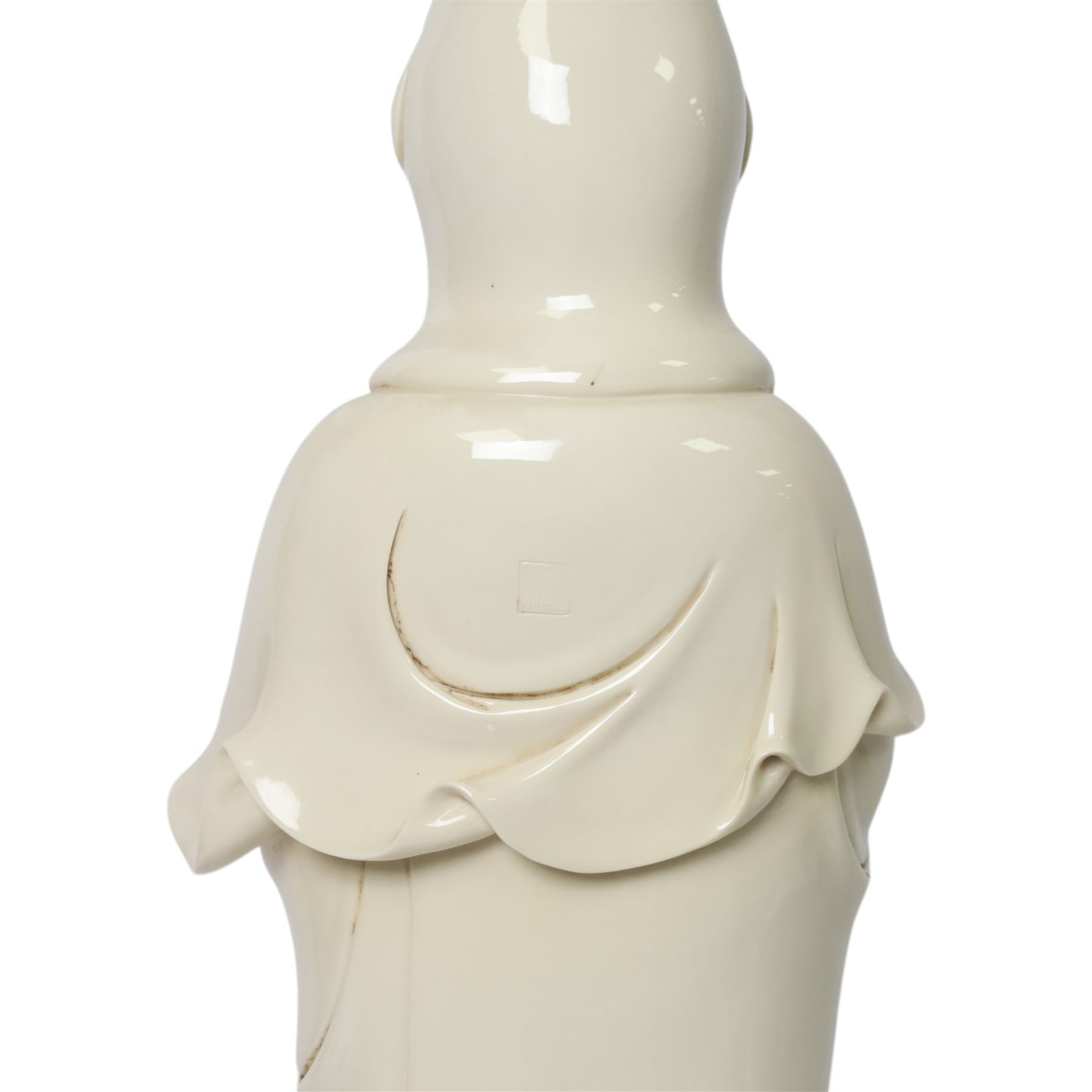 Large Chinese blanc de chine figure of Guanyin, depicting the goddess stood upon a lotus leaf with one hand raised, with potters seal mark to the reverse, H75cm