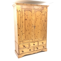 Solid pine double wardrobe, projecting cornice, two doors enclosing hanging rail above three short and two long drawers, shaped plinth base, W148cm, H209cm, D56cm  