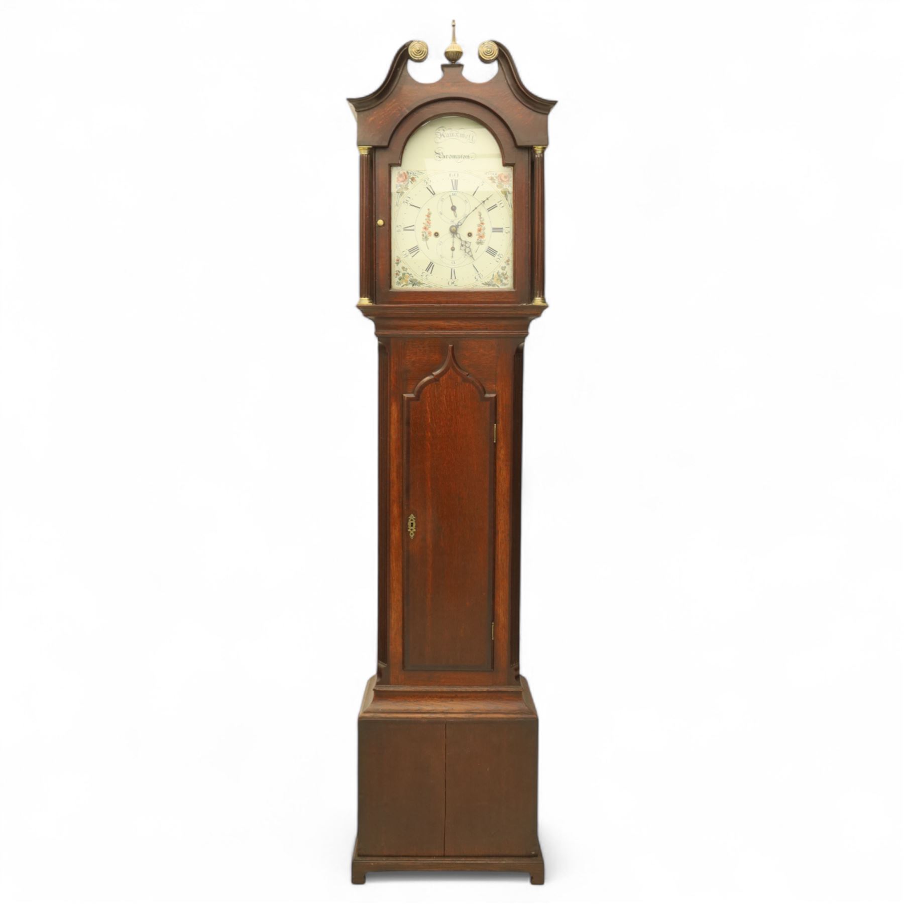Thomas Hawkswell of Brompton (Nr Pickering-Yorks), 8-day oak cased longcase clock with a swan necked pediment and central brass finial, break arch hood door flanked by reeded pilasters with brass capitals, trunk with canted corners and a spire topped door, square plinth raised on a shaped skirting, painted dial with floral spandrels and makers name to the arch, with Roman numerals, calendar and seconds dial and pierced steel hands, dial pinned to a twin train rack striking movement, striking the hours on a bell. With weights and pendulum.