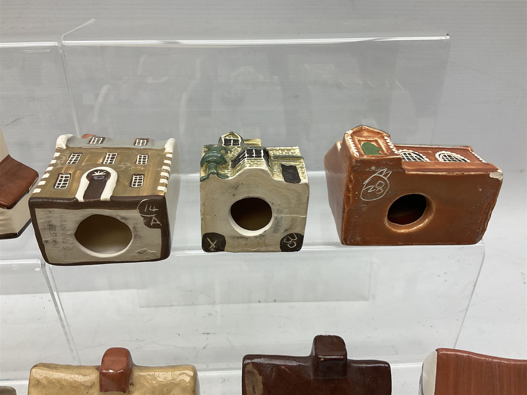 Twenty studio pottery figures of houses and cottages, comprising seventeen Mudlen End Studio Felsham Suffolk examples and two John Putman's Heritage Houses examples