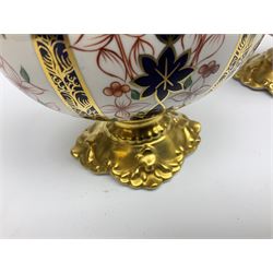 Pair of mid 20th century Royal Crown Derby Imari 1128 pattern Kedleston ewers, each with gilt scroll handle and neck, upon a gilt quatrefoil foot, each with printed marks beneath, H25.5cm