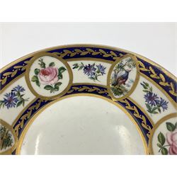 19th Sèvres style porcelain cup and saucer, the cup painted with a figural scene, against a scalloped border of scrolling floral swags on a blue ground, together with a Sèvres soft paste porcelain coffee can and saucer, painted with panels of exotic birds, roses and a border of cornflowers, LL monogram enclosing date letters H above painters mark, coffee can H6.5cm, saucer D13.5cm (2)