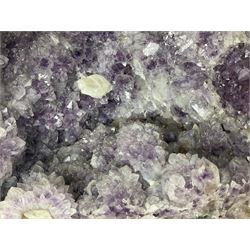 Amethyst crystal ‘cathedral’ geode, free standing with flat base and prepared outer surface, with well-defined crystals of various sizes within the cavern, H36, L35cm