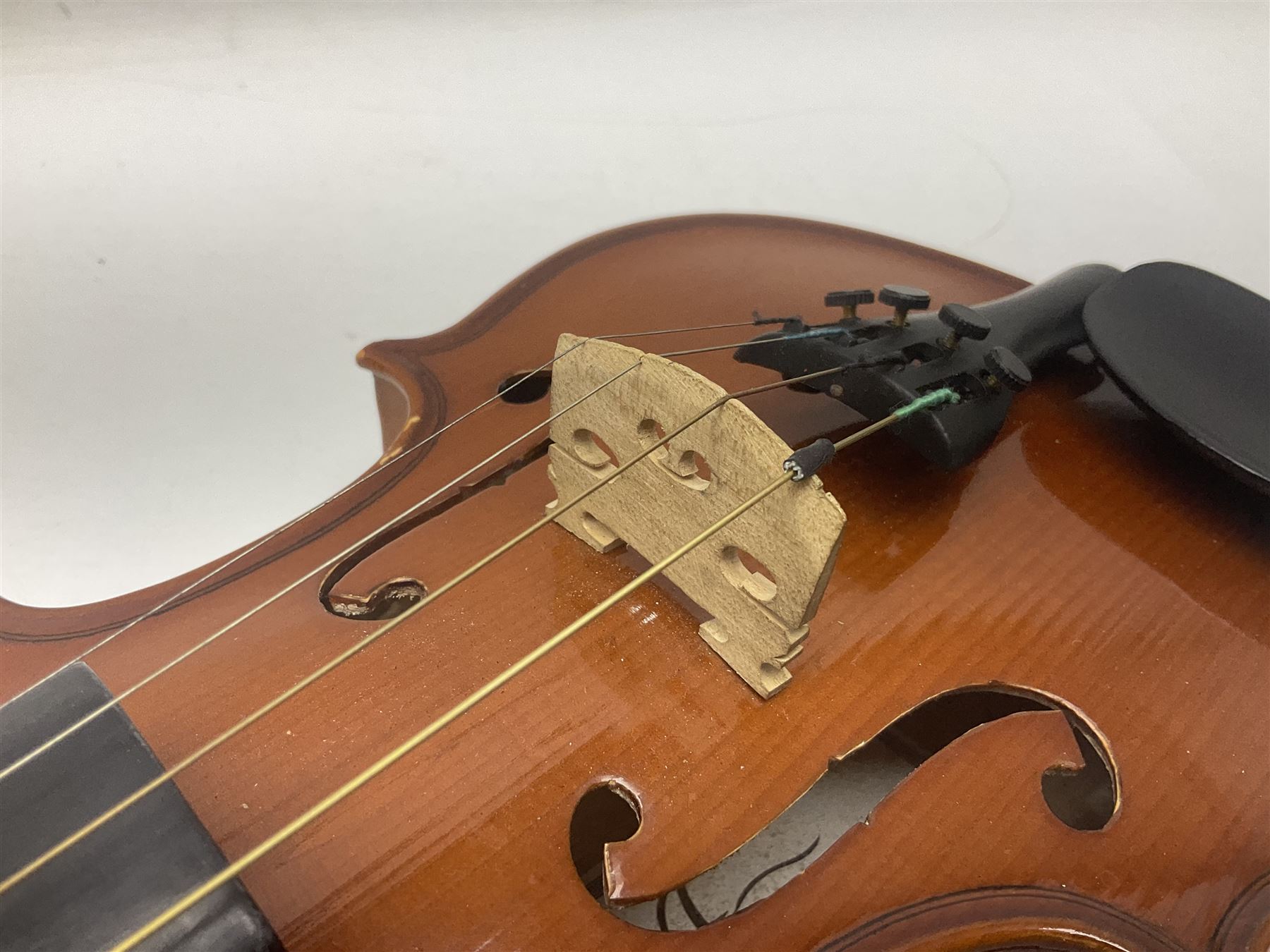 Four Chinese graduated violins - full size with 35.5cm two-piece back; three-quarter size with 33.5cm two-piece back; half size with 31cm two-piece back; and quarter size with 27.5cm two-piece back; all cased except full size; one with bow (4)