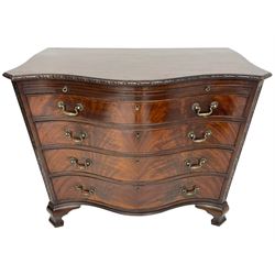 Chippendale design serpentine chest, shaped moulded top carved with repeating flower head motifs, fitted with brushing slide over four graduating drawers, pierced and foliate moulded handle plates with scrolled swan neck handles, canted upright corners carved with flower heads and strapwork, on canted ogee bracket feet