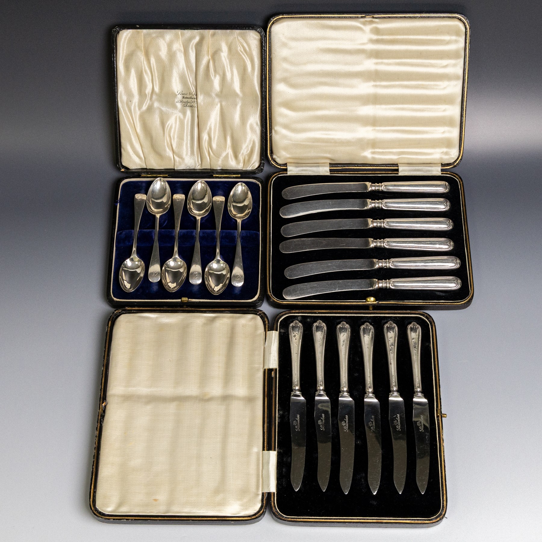 Set of six 1920s silver teaspoons with engraved initials, together with two sets of silver handled tea and fruit knives, all hallmarked and all within fitted cases