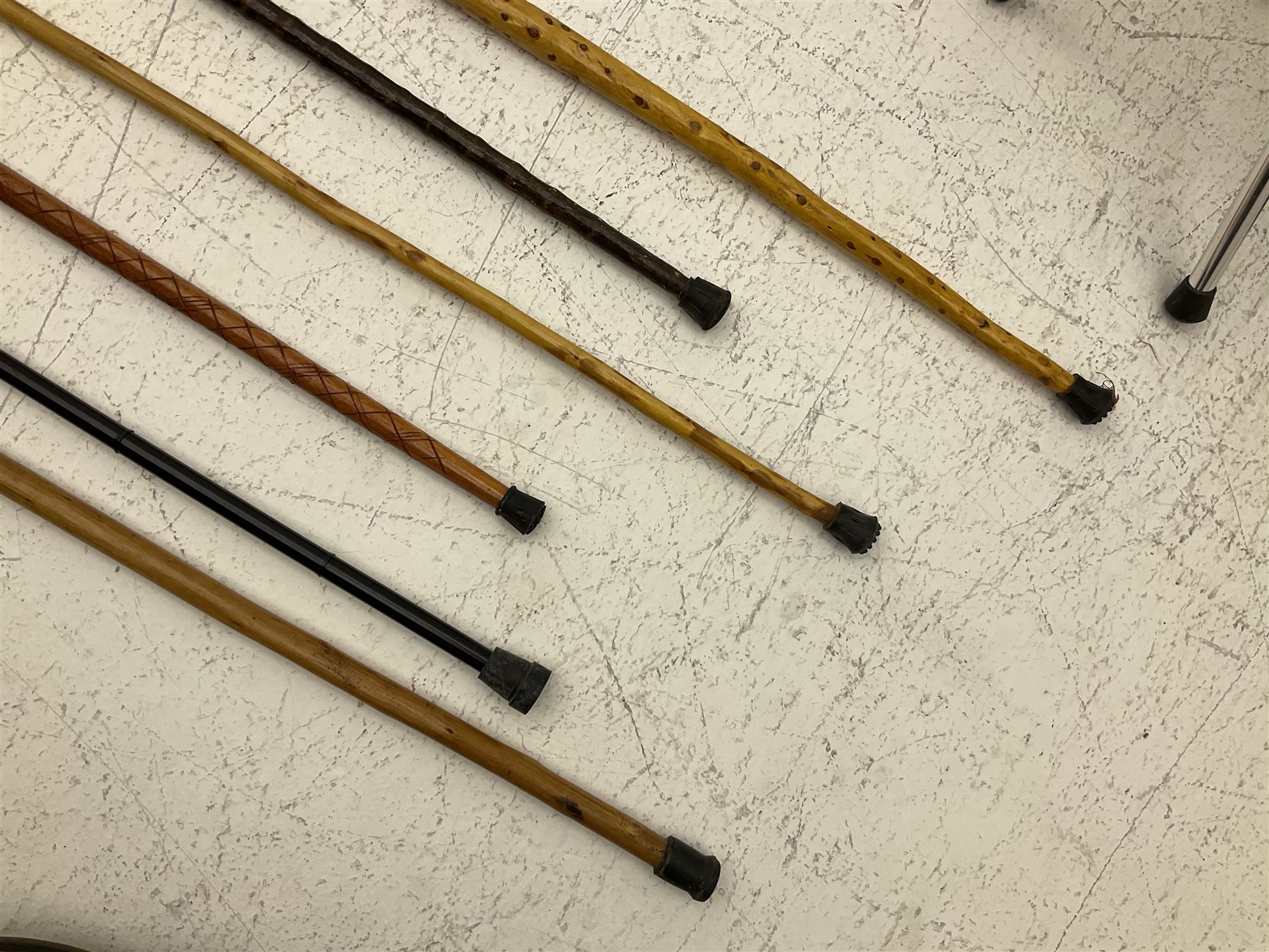 Two smooth polished ram horn handled Shepherd's crooks and a further similar example, together with various shooting sticks, walking sticks and canes, housed in a volcanic lava glaze West German style vase