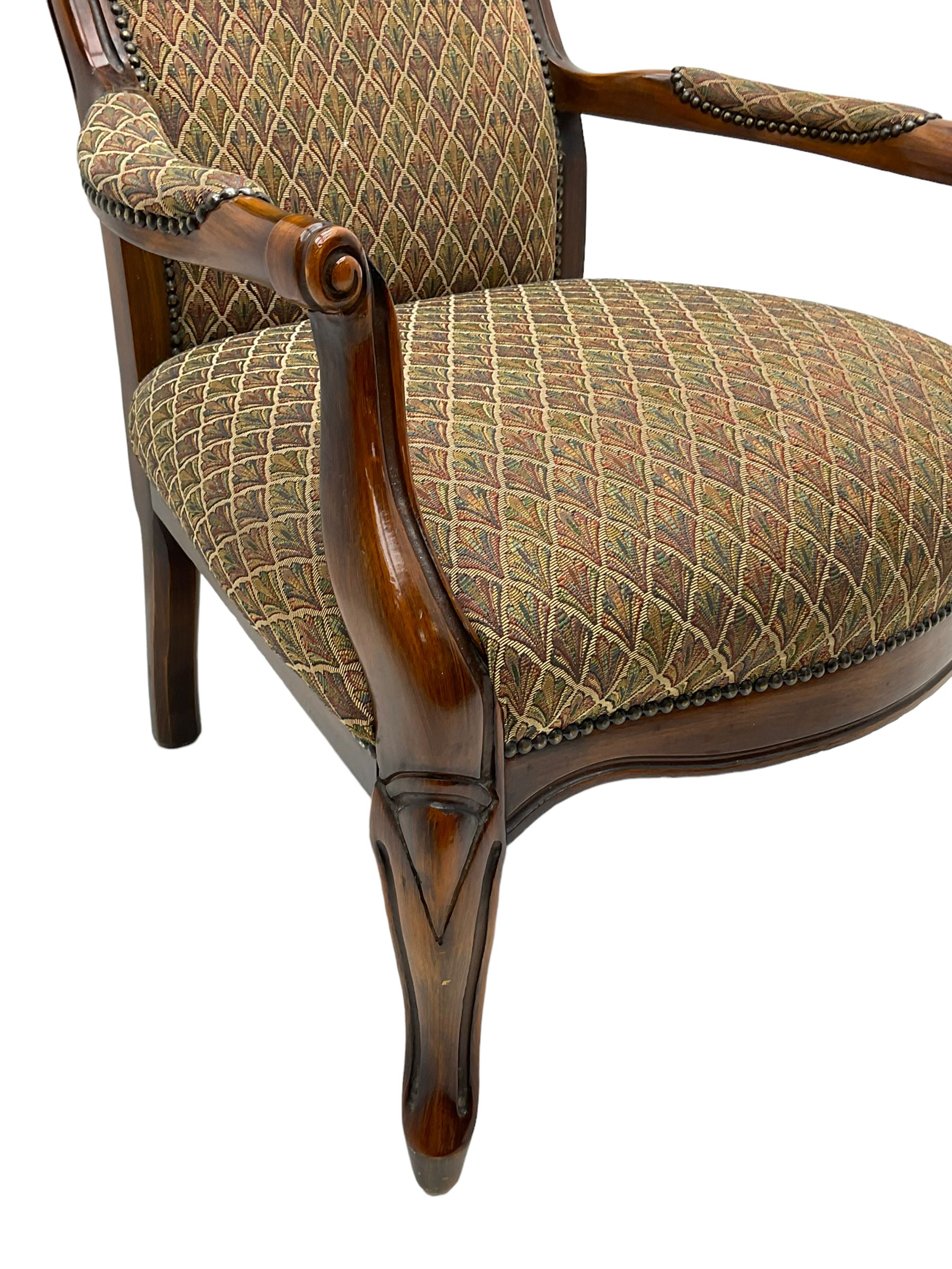 Stained beech framed open armchair, upholstered in foliate pattern fabric, on cabriole front supports