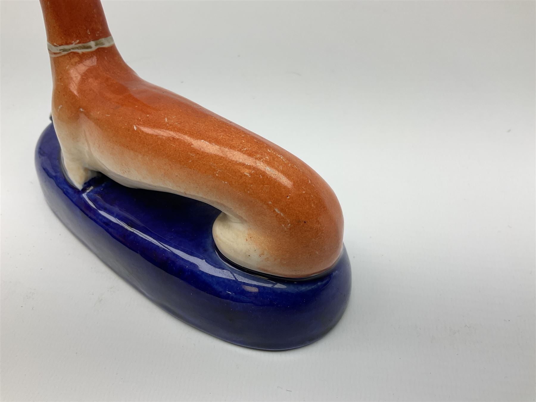 Pair of Staffordshire recumbent greyhound pen holders 