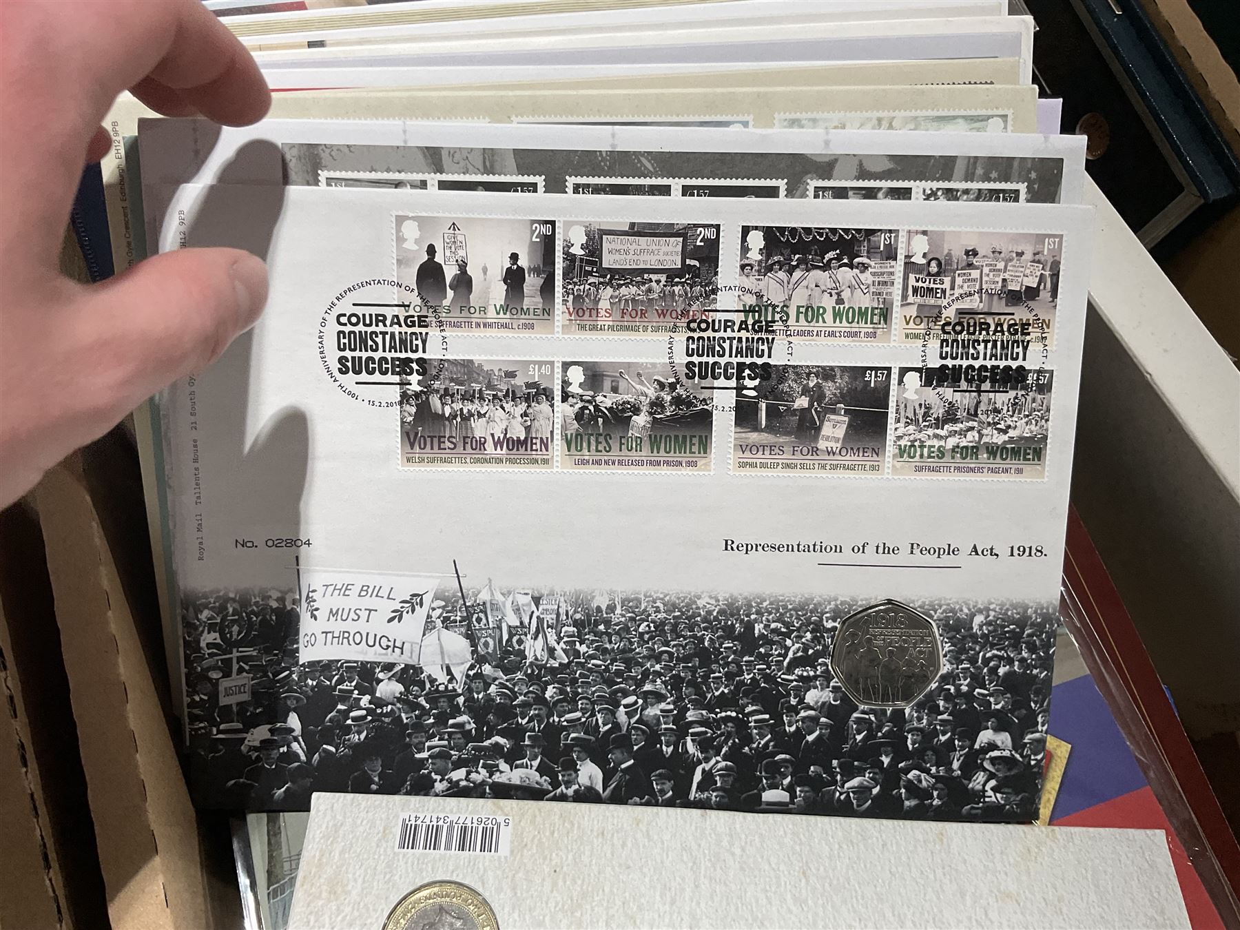 Approximately one hundred and fifteen Royal Mint coin covers, in two ring binder folders and loose, together with approximately 53 grams of Great British pre-1920 and approximately 68 grams of Great British pre-1947 silver threepence coins, and a small quantity of further pre-decimal coins