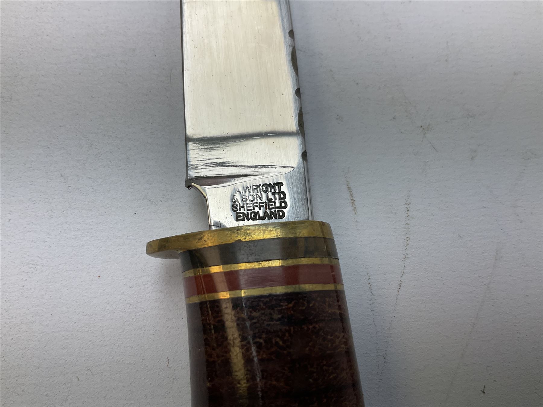 Three hunting knives, each blade marked A. Wright & Sons Sheffield, one with leather handle, one with horn handle and one with antler handle; each with leather sheath (3)