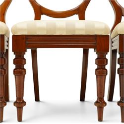 Set of twelve Victorian walnut balloon-back dining chairs, shaped open back over seats upholstered in striped ivory fabric, moulded seat rail above turned and tapering suppors