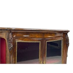 19th century rosewood buffet credenza, bombe form with shaped and moulded top, two central glazed doors with foliate moulded gilt slips, the red fabric-lined interior fitted with a single shelf, flanked by open shelves with raised gilt metal lips, the uprights decorated with shell and flower head carved cartouche mounts, acanthus leaf scroll carved lower mounts, on shaped and moulded plinth base 