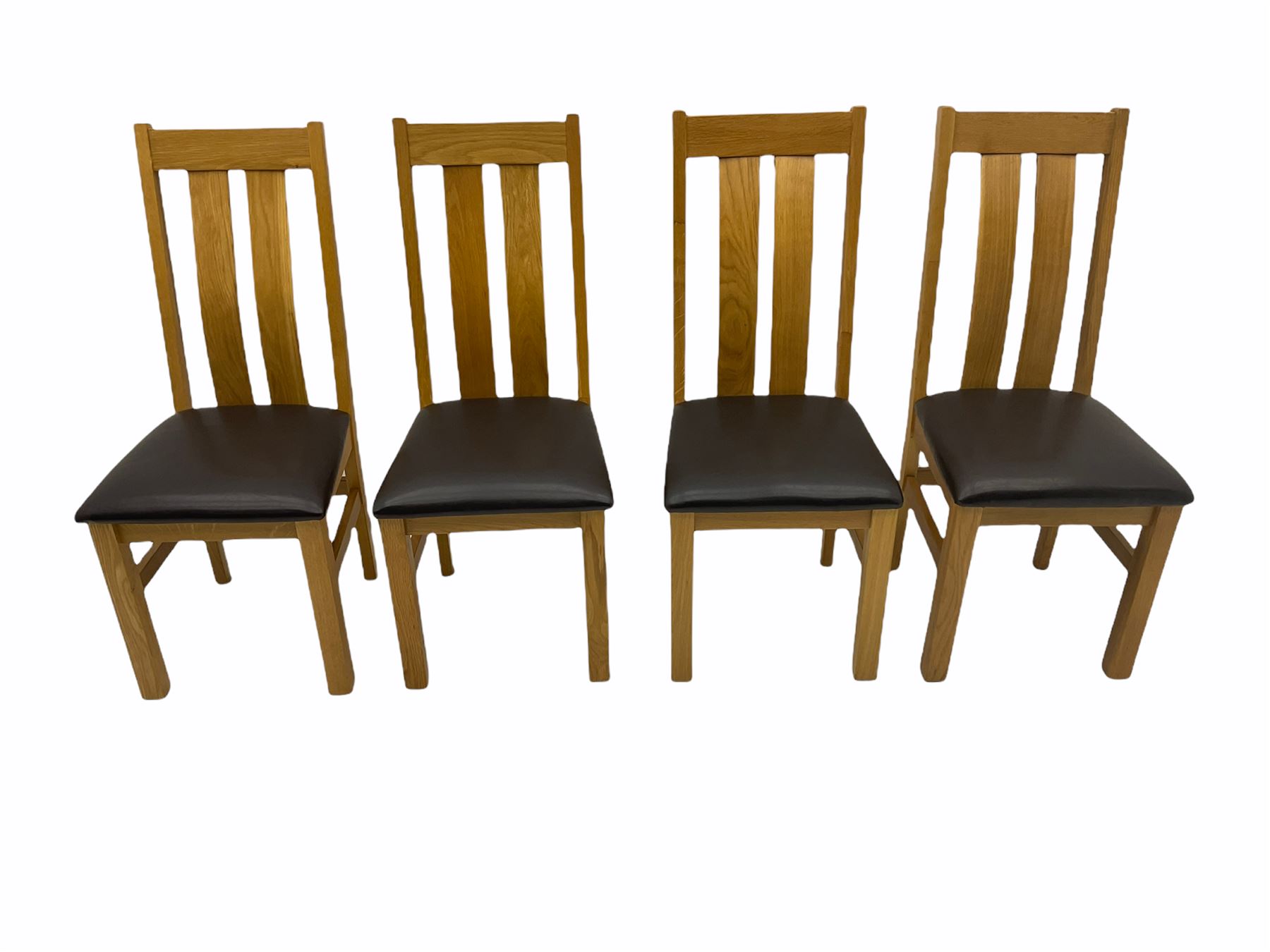 Solid oak oval extending dining table, butterfly leaf extension, four chairs with brown upholstered seats