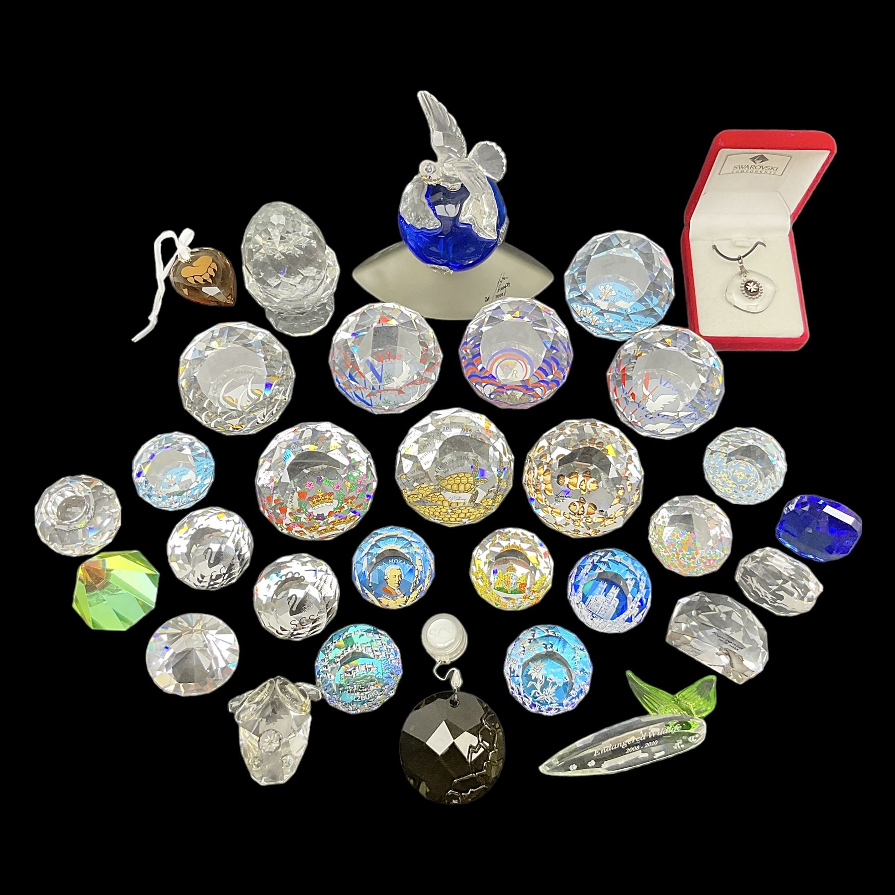 Swarovski Crystal paperweights, to include a globe with dove to the top, pyramid shapes etc, together with a large collection of boxes and stands  