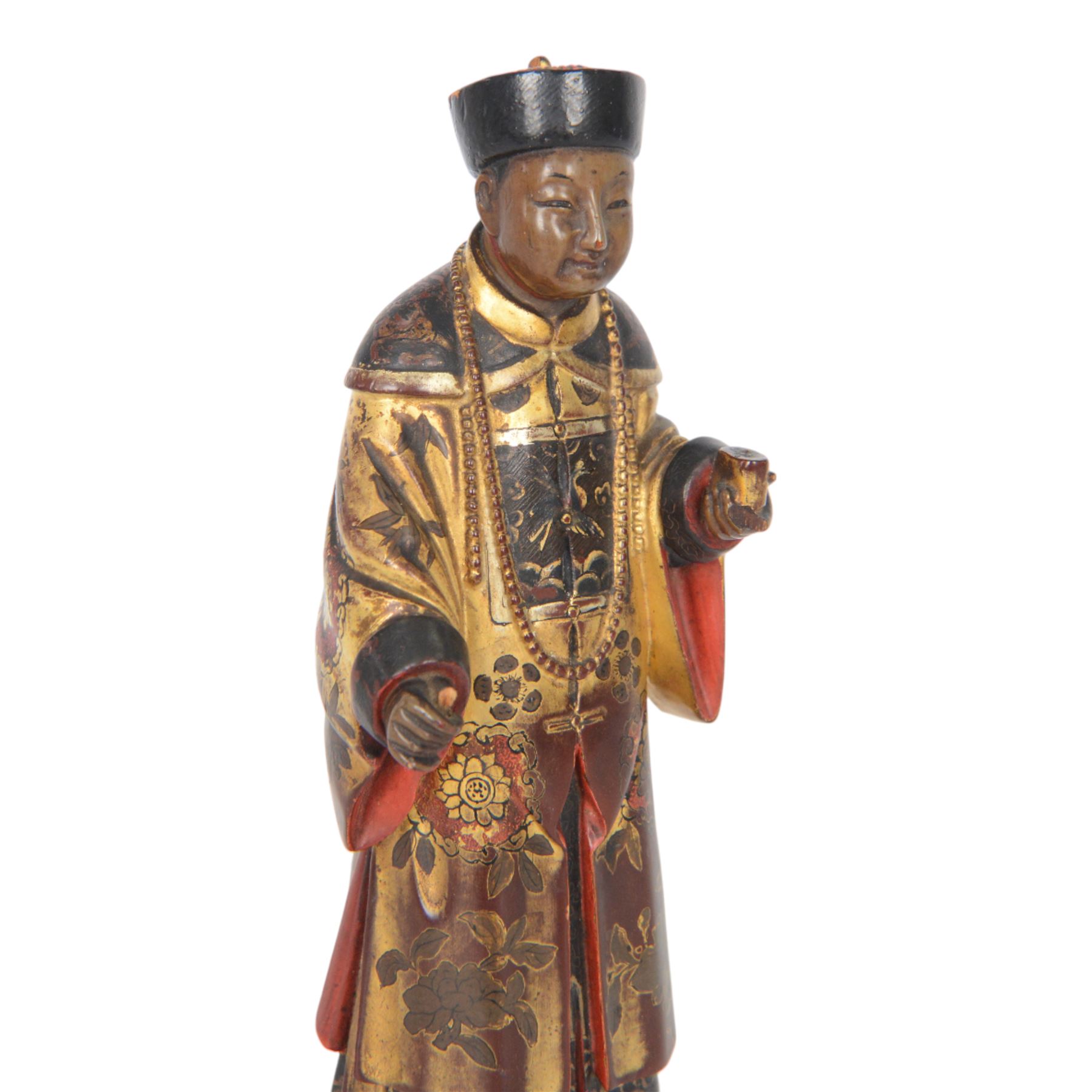 Pair of Asian carved wooden lacquered figures, in ceremonial dress, possibly wedding attire, highlighted throughout in gilt, H22cm