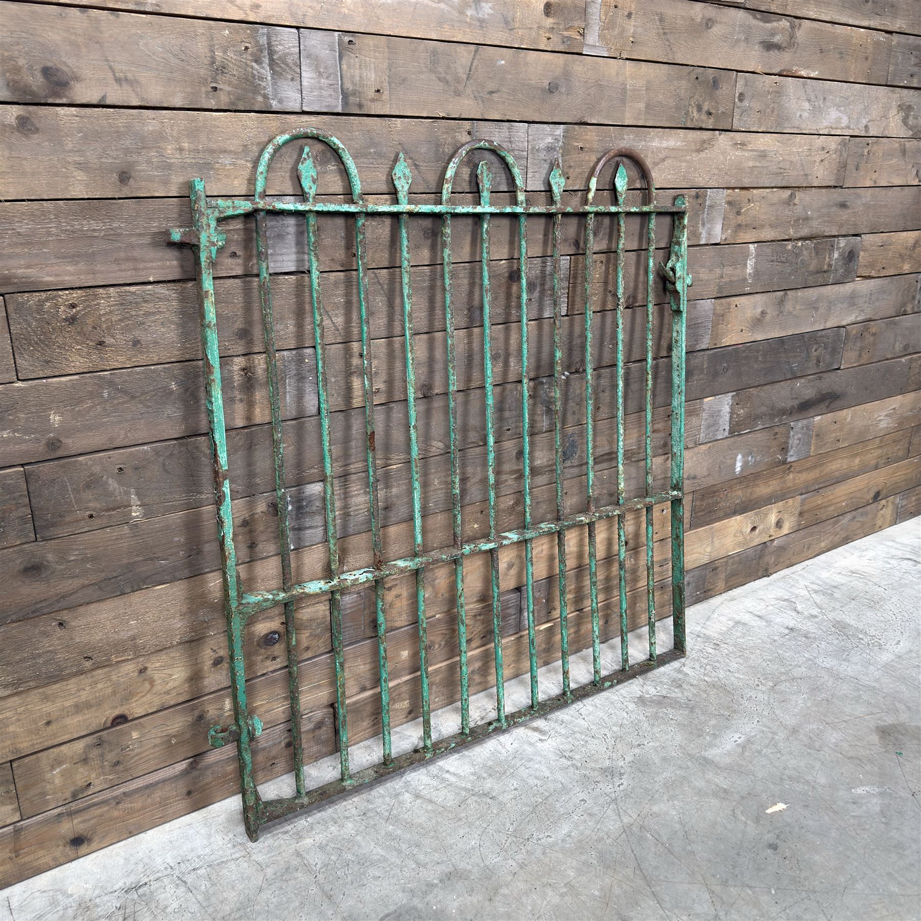 19th century French cast iron garden gate, finished in green rustic paint, bar form with hoop and spear top, with loop hinge brackets