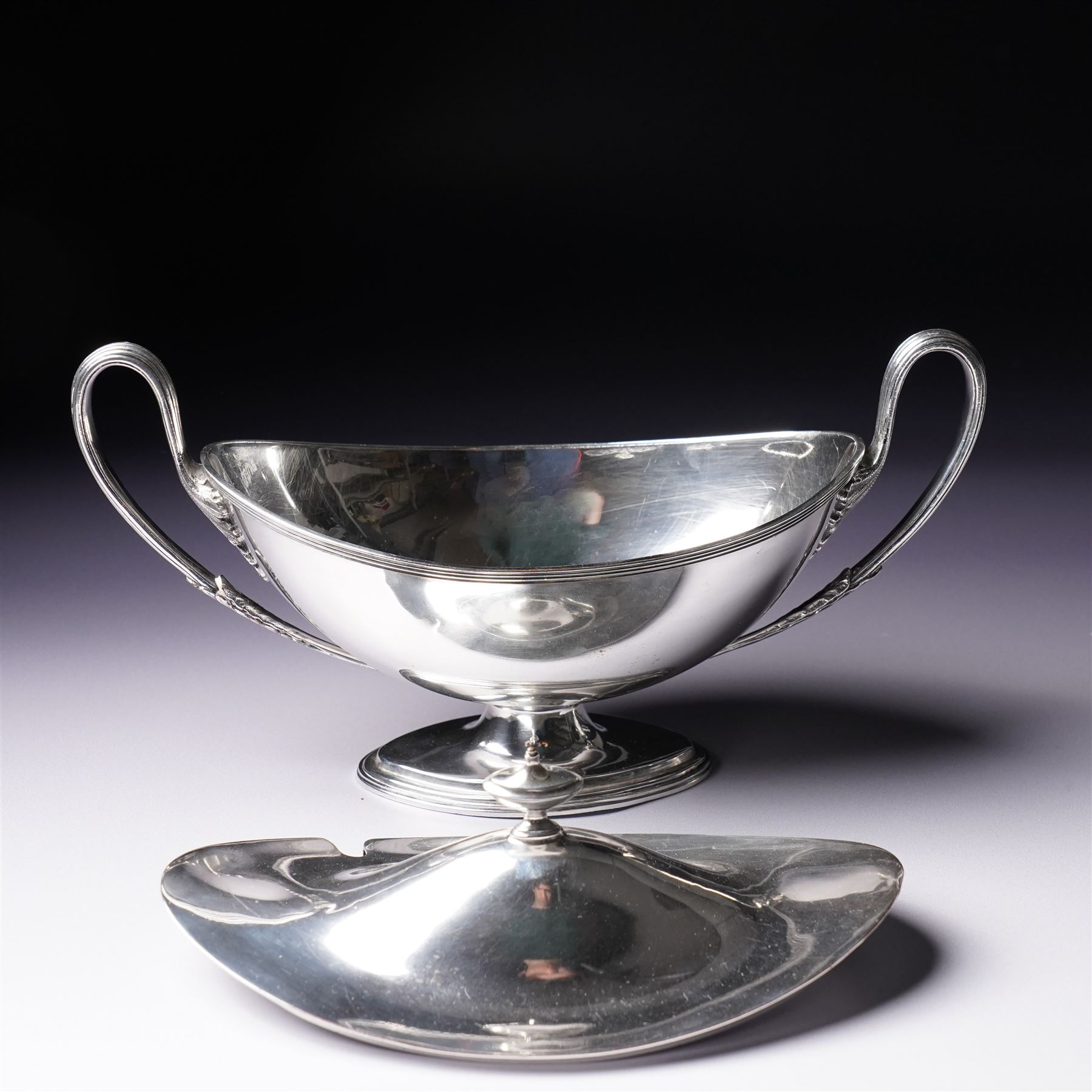 Pair of silver plated sauce tureens and covers of oval form with reeded loop handles L25cm overall
