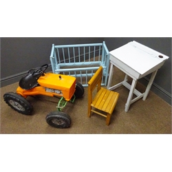  Childs Tri-ang pedal tractor, orange plastic moulded body, black wheels and black metal seat, child's desk and chair and dolls cot   
