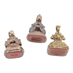 Collection of four 19th century gold plated seals with carnelian matrixes, together with three seals including an agate example, largest seal H3.5cm