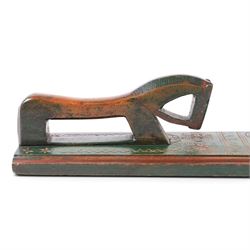 Mid 19th century Norwegian carved mangle board, dated 1836, of rectangular form with carved dala horse handle, with geometic red floral carvings upon a green ground, L63cm