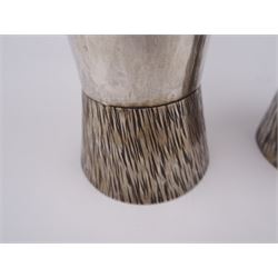 Pair of modern Guild of Hull Silversmiths silver goblets, the bowls each of tapering cylindrical form, with spot hammered finish, upon a tapering foot, etched with abstract lines, hallmarked J & KR, Birmingham 1983, also marked with the three crowns mark of the Guild of Hull Silversmiths, H11.6cm
Notes: Abraham Barachin was the last Hull silversmith to use the Hull mark of three ducal coronets in around 1706. However in 1983 the Assay Offices of Great Britain and the City of Kingston upon Hull granted the Guild of Hull Silversmiths permission to use the City's Coat of Arms as an additional mark on pieces they produced