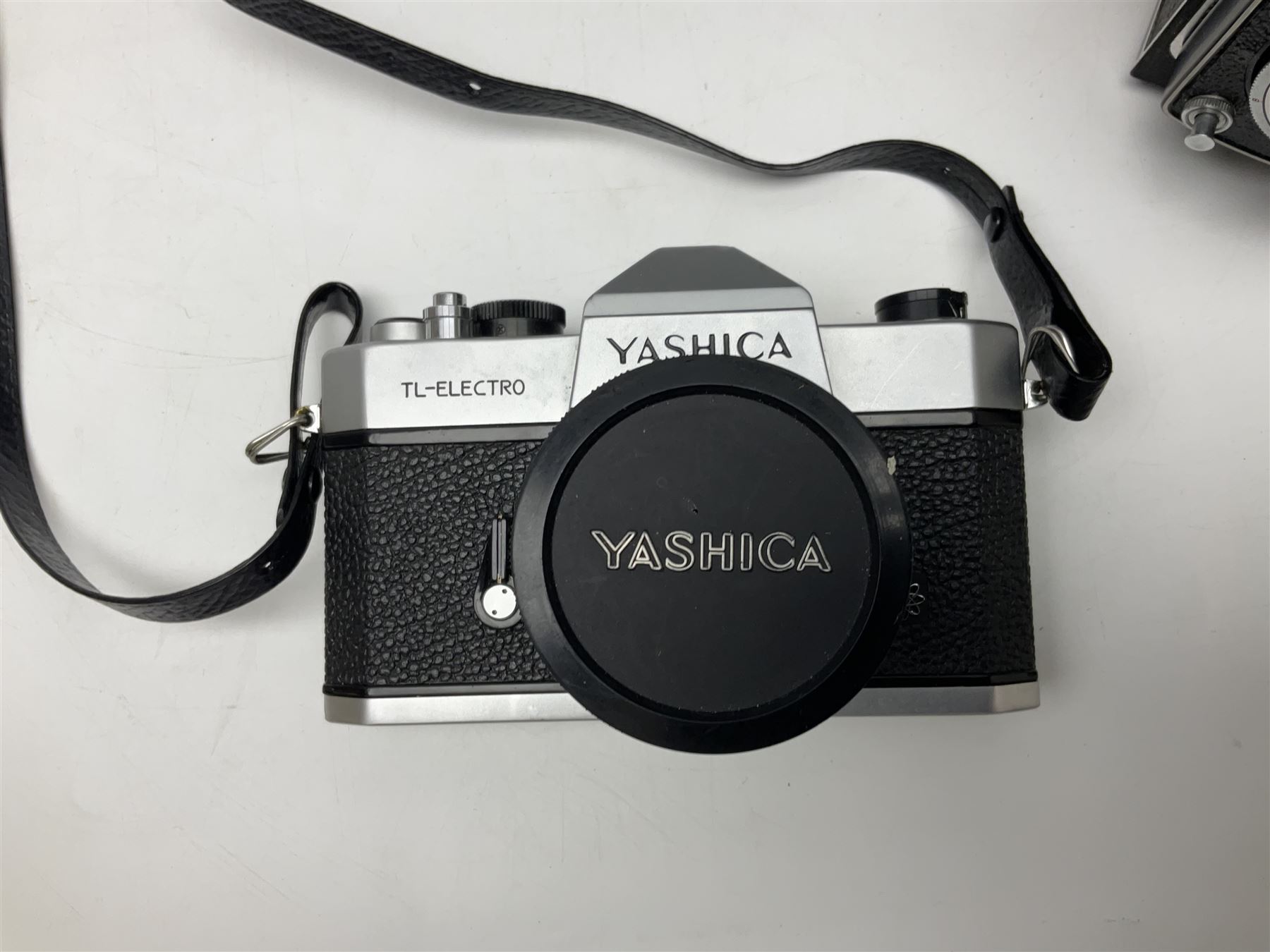 Yashica-A camera body, serial no. A4080073, with 'Yashikor 1:3.5 f=80mm' lens, serial no. 209272 and 'Yashikor 1:3.5f=80mm' lens, serial no 22942, together with Yashica TL-Electro camera body, serial no. 5054162 with 'Yashinon-DS 50mm 1:1.9  40056038
