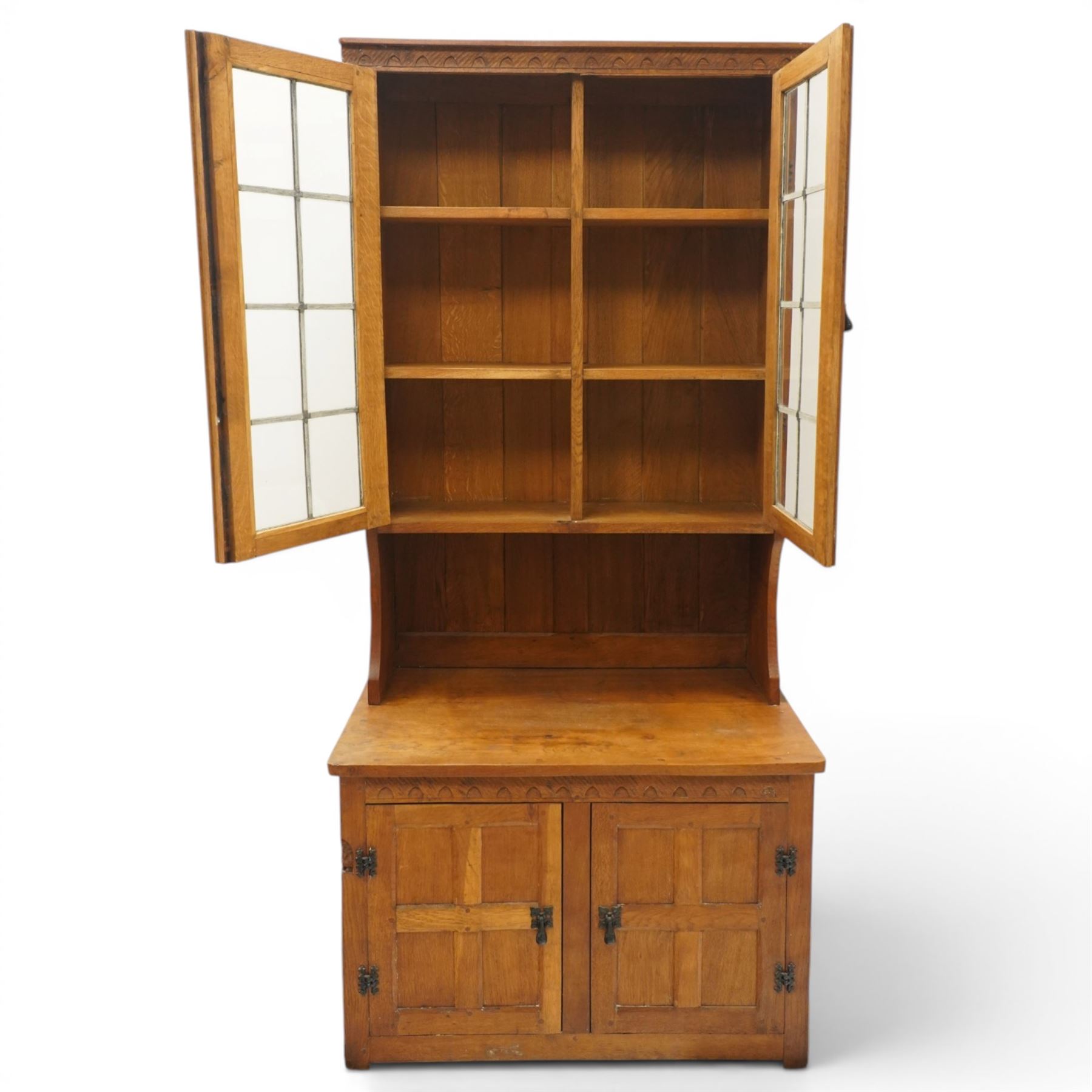 Gnomeman - adzed oak dresser, arcade carved cresting rail over two lead glazed doors, double cupboard below enclosed by two panelled doors, with carved gnome signature, by Thomas Whittaker of Littlebeck 