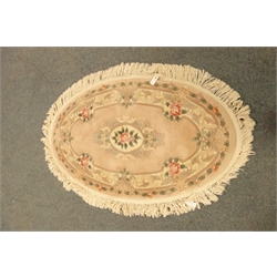  Chinese wool oval rug, worked with flowers on a pink ground, 145cm x 90cm  