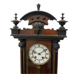 A spring driven “Vienna” regulator in a mahogany and ebonised case, with applied carving and finals, two-part enamel dial with Roman numerals and steel gothic pierced hands, 8-day Lenzkirch movement striking the hours on a gong, with visible gridiron pendulum. 
