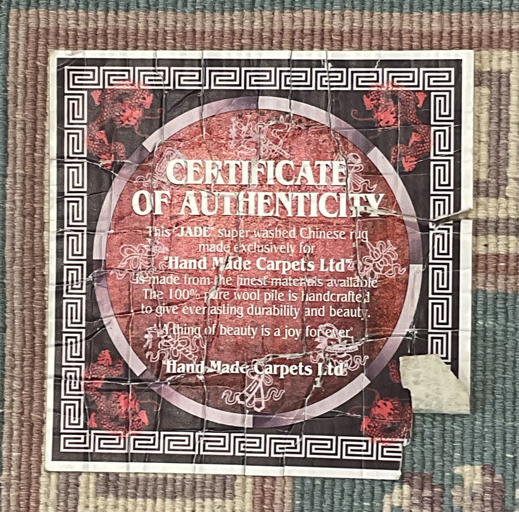 Chinese jade ground woollen rug decorated with dragons 