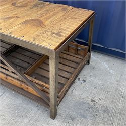 Large reclaimed industrial wrought metal and pine table, pine plank top on wrought metal base, the undertier fitted with wooden storage trays 