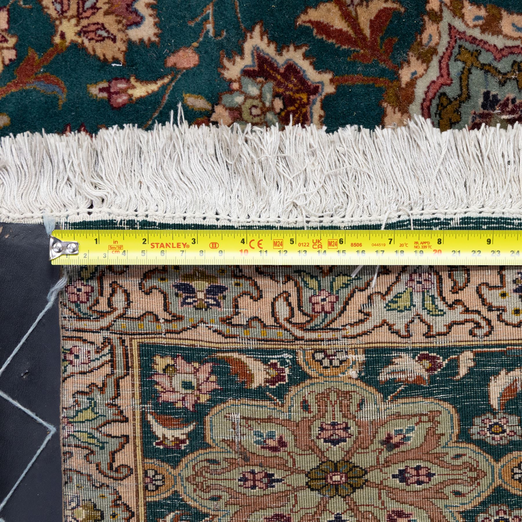 Persian Tabriz type carpet, the teal ground decorated with central medallion, radiating palmettes and dense floral scrollwork, within multiple floral borders