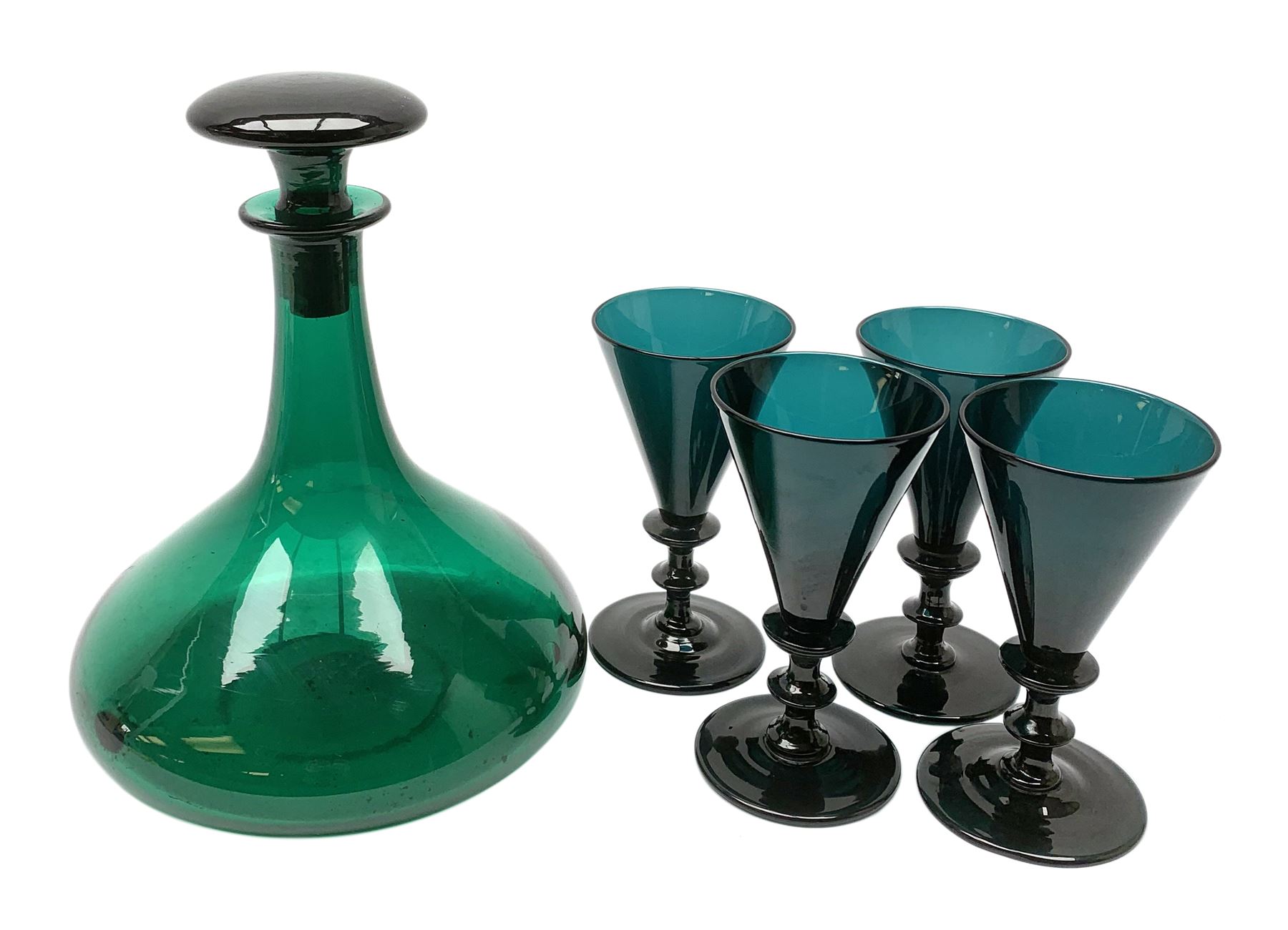19th century green glass ships decanter with flat topped stopper, H21.5cm, together with a set of four 19th century green glass wine glasses, the funnel bowls upon bladed knopped stems and circular feet, H13cm
